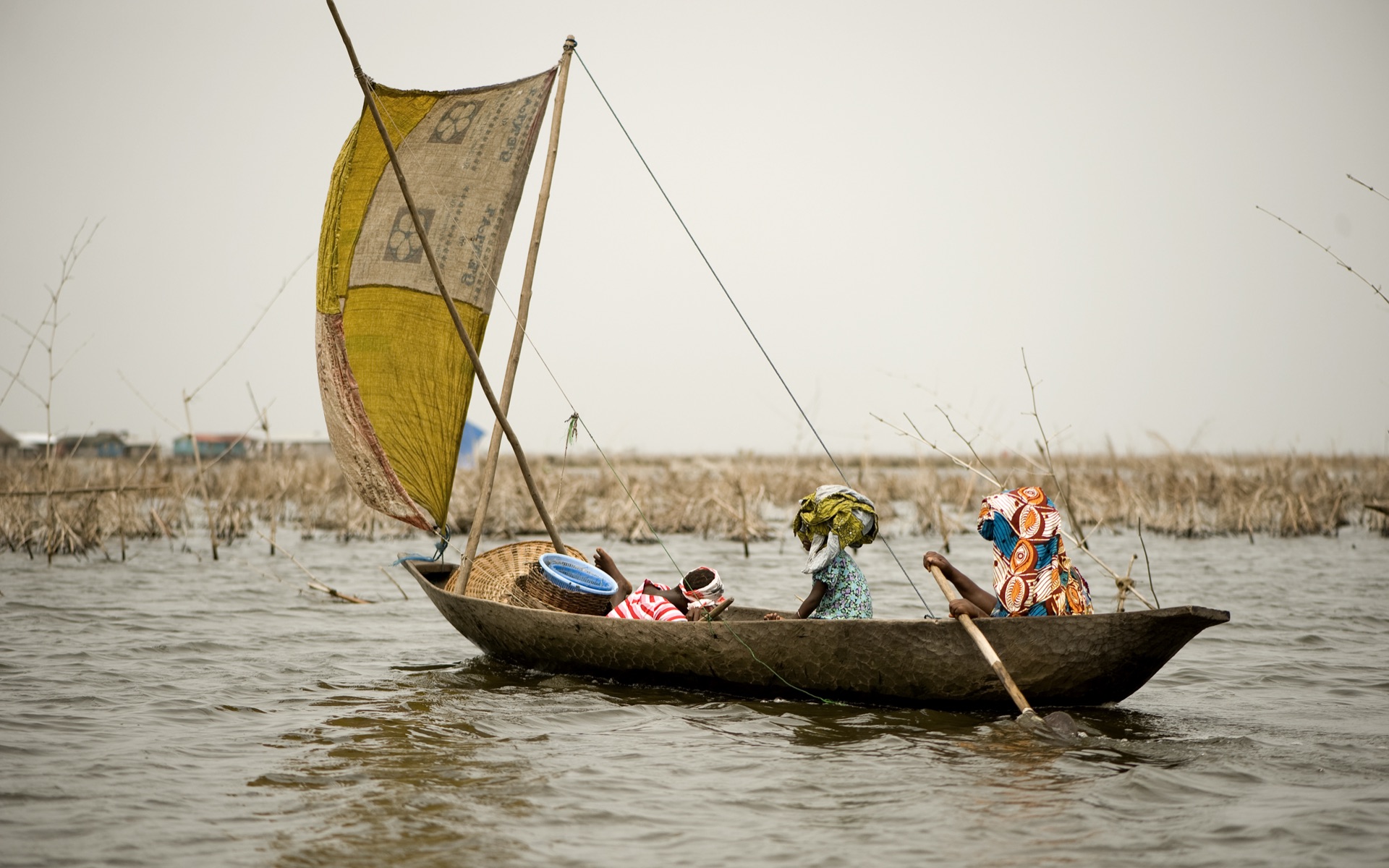 African women fishing from traditional boat on river